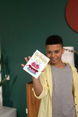 Boy holding birthday card and smiling
