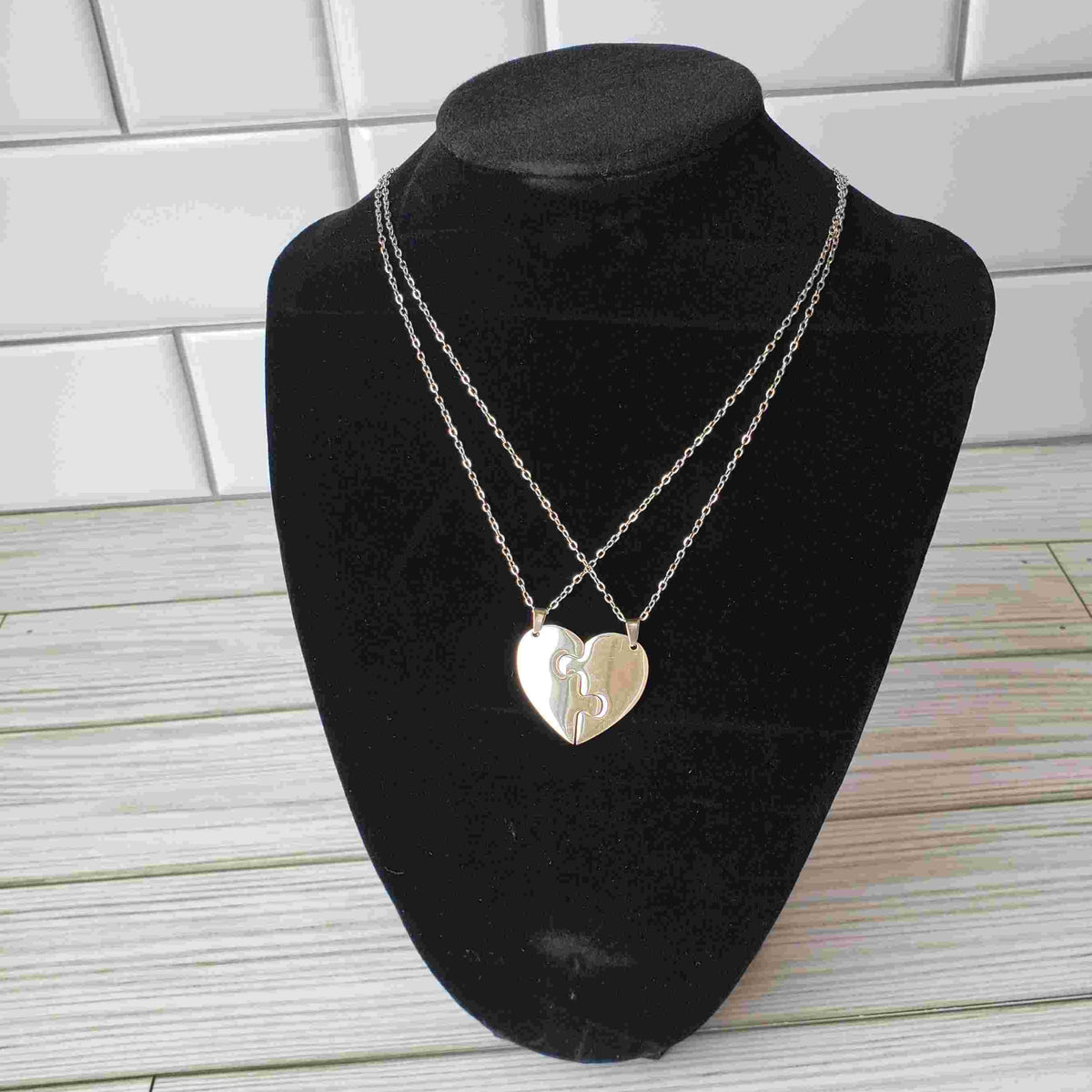 A mother's heart necklace with 2 pieces in silver.
